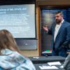 Attorney Edward Dindinger discussing Idaho firearms law with students, using slideshow.