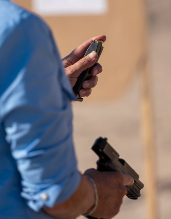 Student at MoD.Handgun.1 demonstrates "indexing" the magazine at an outdoor range.