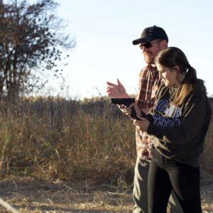 Bryan and student learning with a handgun.
